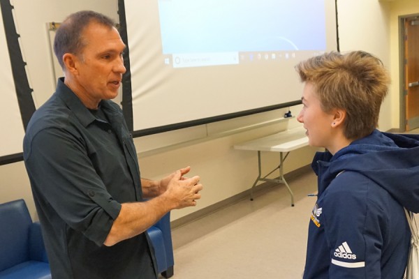 Olympic decathlete Dave Steen gives Lancer long jumper Ashley Langelier a few pointers after speaking to her class in sports ethics.