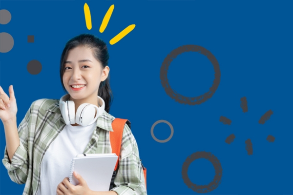 young person smiling and holding notebook