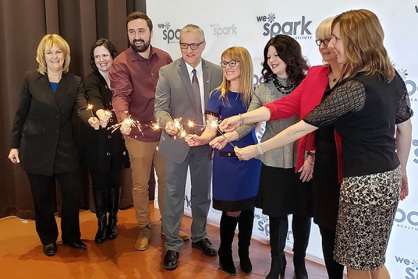 Cathy Mombourquette, Marla Rivard, Kyle Lago, Robert Gordon, Lisa Porter, Patti France, Janice Kaffer, Karen Metcalfe holding sparklers