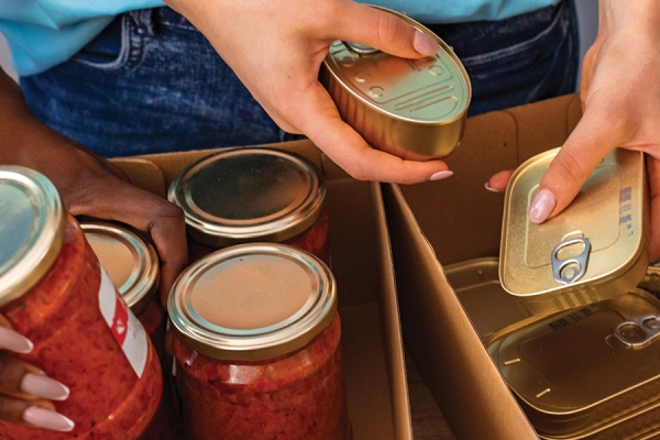 hands loading foods into boxes