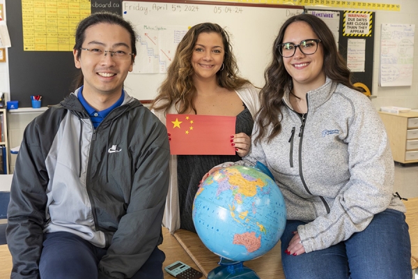 Yuyang Hua, Elizabeth Dalla Bona, and Sophia Boschin pose with globe