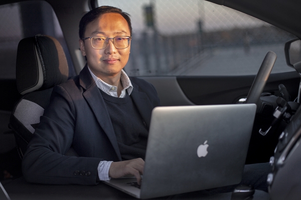 Ning Zhang using laptop to analyze car