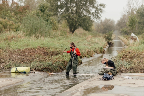 students mucking about in Grand Marais drain