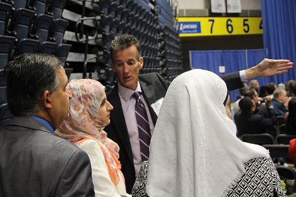 Assistant registrar Mark Trudell helps guests find their seats during the Fall 2016 Convocation.