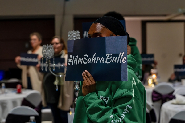 woman holding sign I am Sahra Bulle