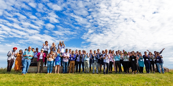 a line of conferfees standing outdoors