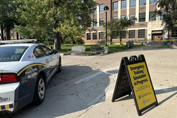 campus police car parked outside Memorial Hall