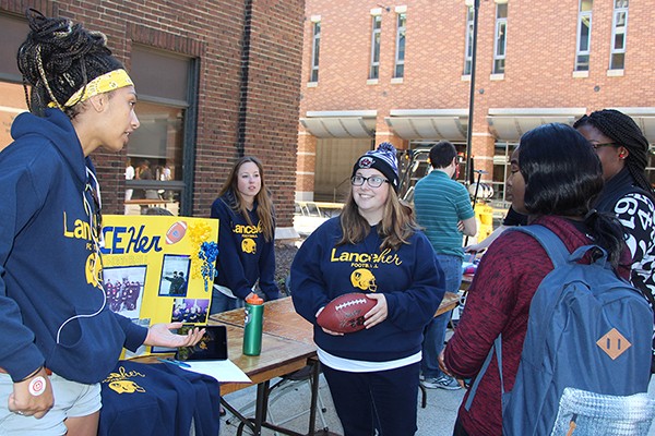 Members of the LanceHer football club talk up their sport to some potential new recruits. 