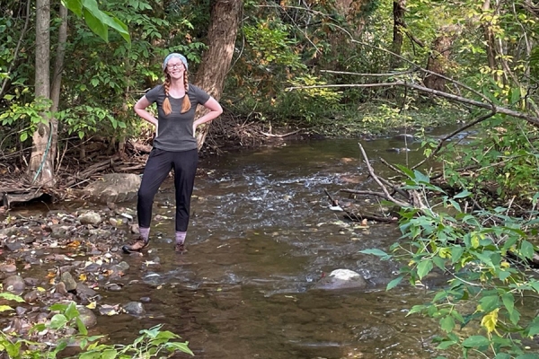 Ashley Watt stands in a stream