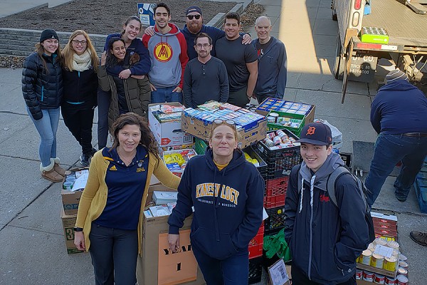 Volunteers load a truck with canned foods for delivery to the Downtown Mission.