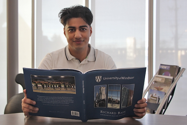 Kumayl Hooda holding a photobook