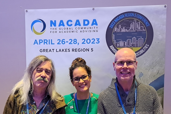 Denis Tetreault, Danielle Handsor-Matias, and Chris O’Gorman pose under conference banner