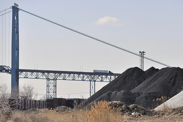 piles of petcoke pictured under Ambassador Bridge