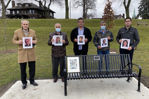 People hold photos of those lost