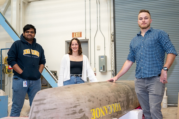 Shasank Natakam, Katie Sinn, and Valdemar Kochanowski by concrete canoe.