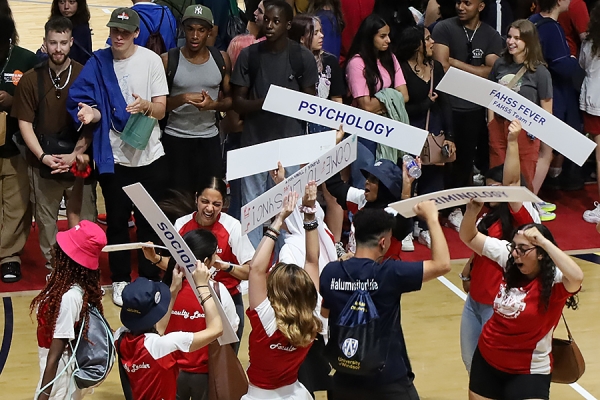 students holding program signs during orientation
