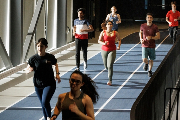 people exercising on indoor track