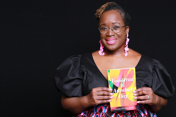 Dwania McLarty-Peele holding her book Tomorrow is Another Day