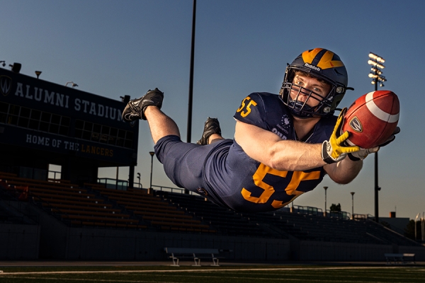 football player catching pass