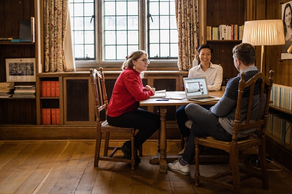 Rhodes Scholars conversing around table