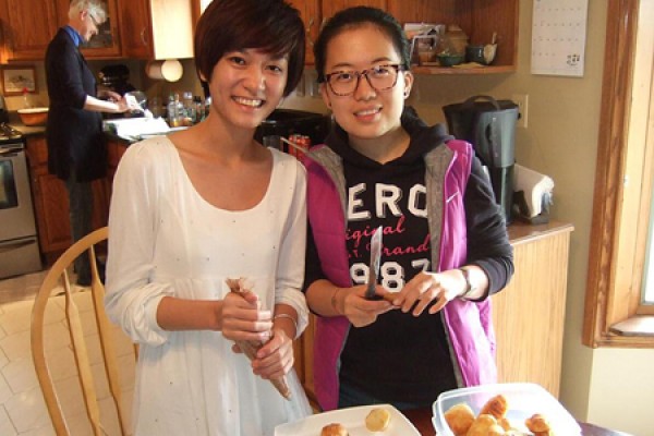 Student guests help prepare dessert for their holiday hosts.