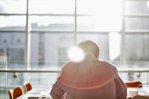 person sitting in sunny window