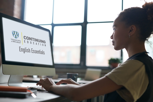 student looking up English Essentials on computer