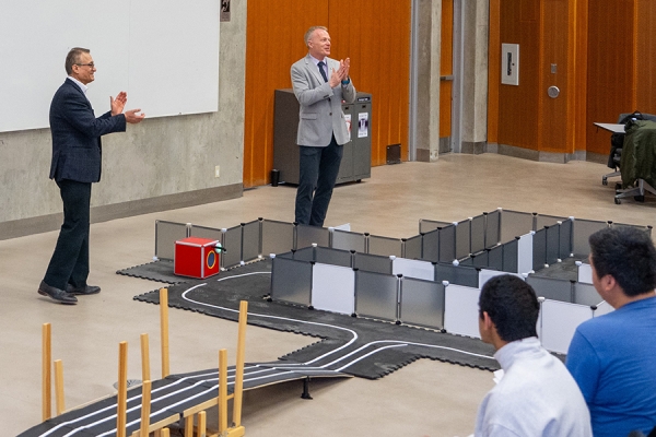 professors standing near obstacle course