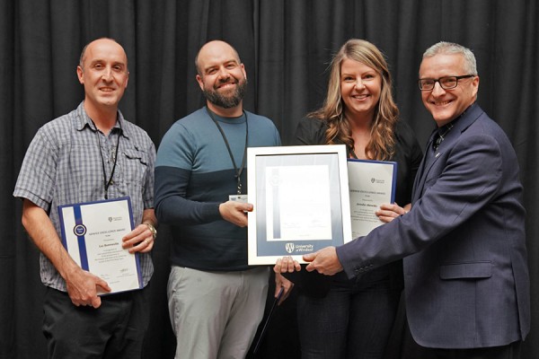 Luc Quenneville, Scott Thorpe, and Jen Almeida accept certificates from president Robert Gordon.