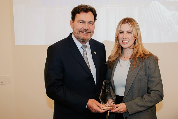 Richard Wagner hands trophy to Kathleen Kennedy