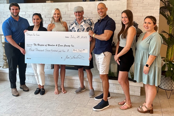 group of people holding oversized novelty cheque