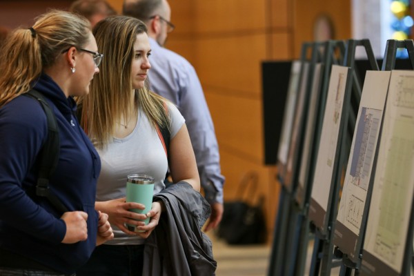 UWindsor students Monica Sokolowski and Stephanie Milling examine the architectural renderings for the Lancer Sport and Recreation Centre during the open house on Wednesday, Feb. 28, 2018.