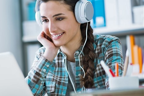 woman gazing happily at computer