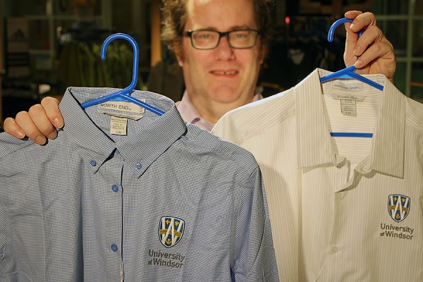 Martin Deck holding shirts.