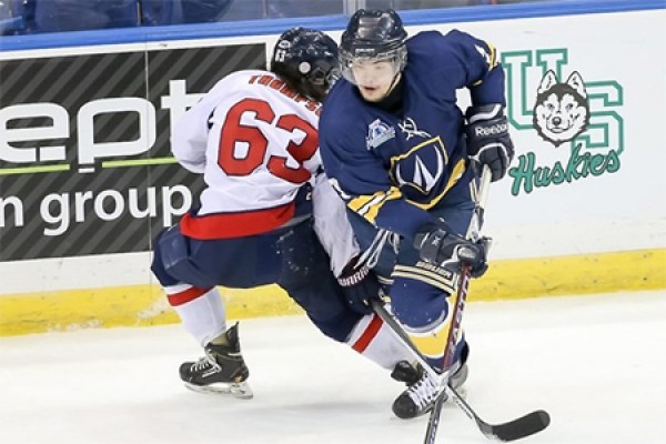 hockey players struggle for puck control