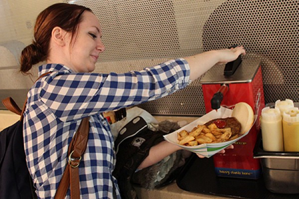 Rayna Lamond tops her burger with French’s ketchup.