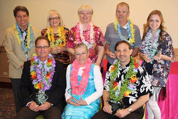 Dean of students Clayton Smith congratulates GEM Award winners Laura Handsor, Ann Marie Hranka, Tim Kenney, Ashley Seguin and (seated) Mike MacKinnon, Rosemary Briscoe and Chris Zelezney.