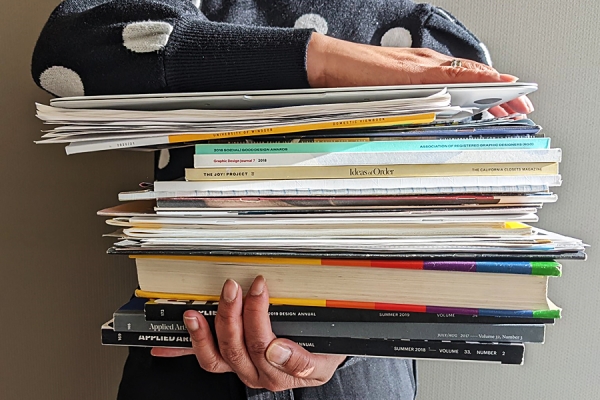 woman holding stack of paperwork