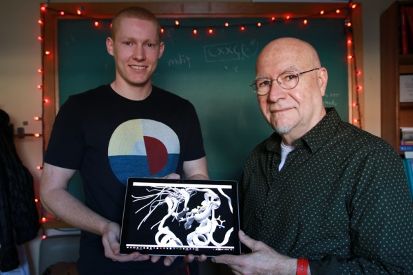 UWindsor biochemistry graduate student Cody Caba and professor Bulent Mutus display the crystal structure of protein disulfide isomerase. Mutus received an NSERC Discovery Grant to examine cell proteins and structures and how they contribute to diseases.