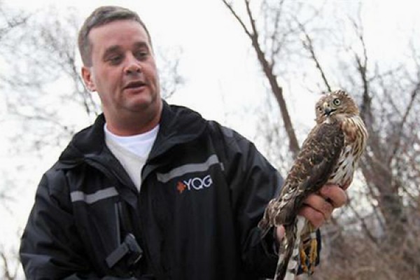 Conservationist Phil Roberts holding a raptor.