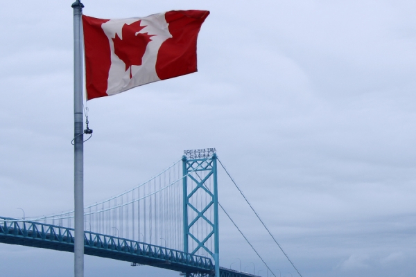 Canada flag flying on riverfront