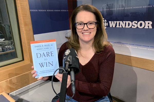 Chantal Vallée holding book in recording studio