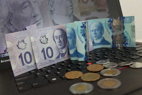 computer keyboard covered with money