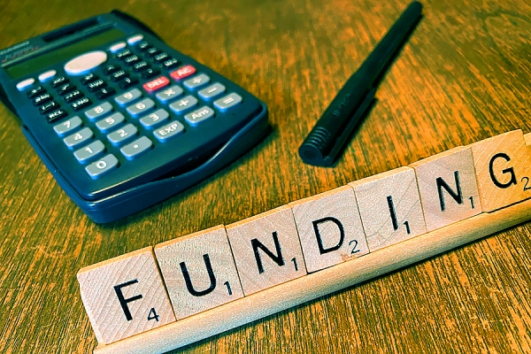 scrabble tiles spelling funding