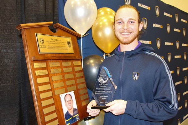 Graham Reid holding award statuette