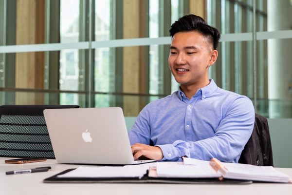 student at laptop computer