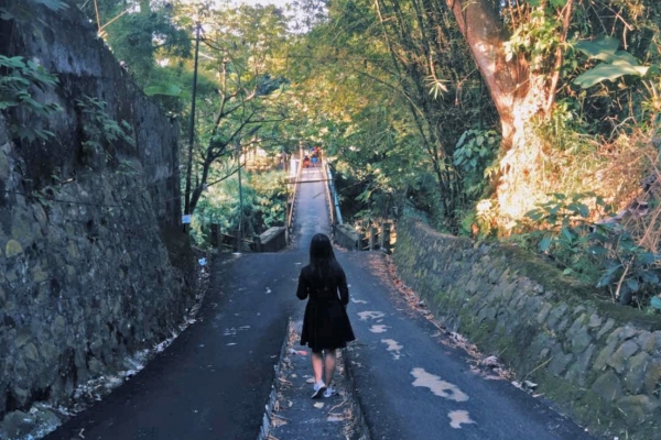 young woman walking through rural area