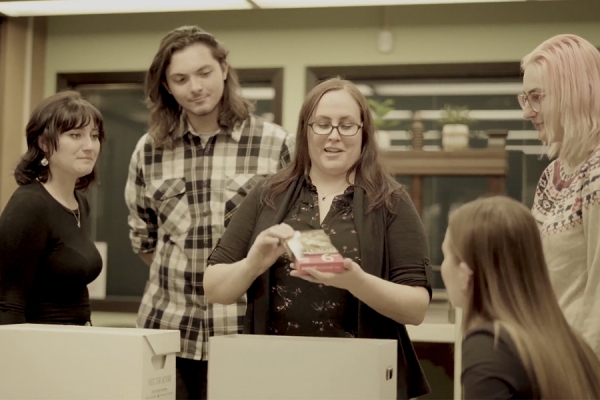 archivist displaying object to students