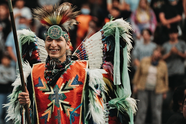 smiling dancer in full powwow regalia