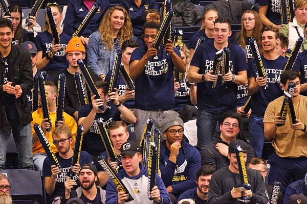 students cheering in grandstands